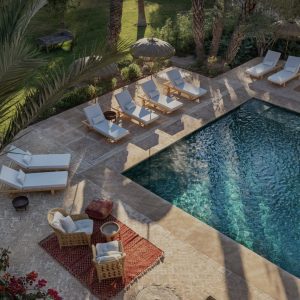 Resort pool with lounge chairs and palm trees
