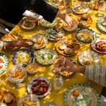 A table full of food with people eating